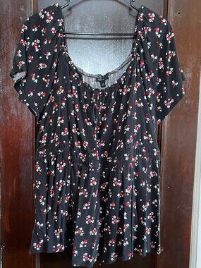Babydoll peplum top with flutter sleeves, black with red and white flowers